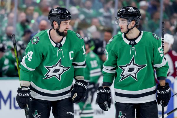 Dallas Stars left wing Jamie Benn, left, and center Wyatt Johnston, right, skate together before a face-off during the first period of Game 5 of a first-round NHL hockey playoff series against the Colorado Avalanche in Dallas, Monday, April 28, 2025. (AP Photo/Gareth Patterson)