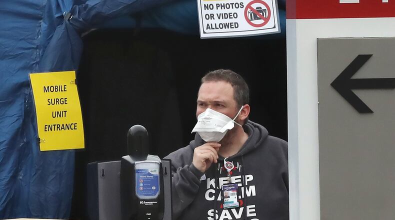 “Keep calm save lives” says the shirt worn by a medical worker at the surge unit at WellStar Kennestone in Marietta. Curtis Compton ccompton@ajc.com