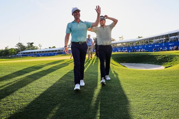 Ben Griffin, left, walks off the 18th green with teammate Andrew Novak, after they won the PGA Zurich Classic golf tournament at TPC Louisiana in Avondale, La., Sunday, April 27, 2025. (AP Photo/Gerald Herbert)