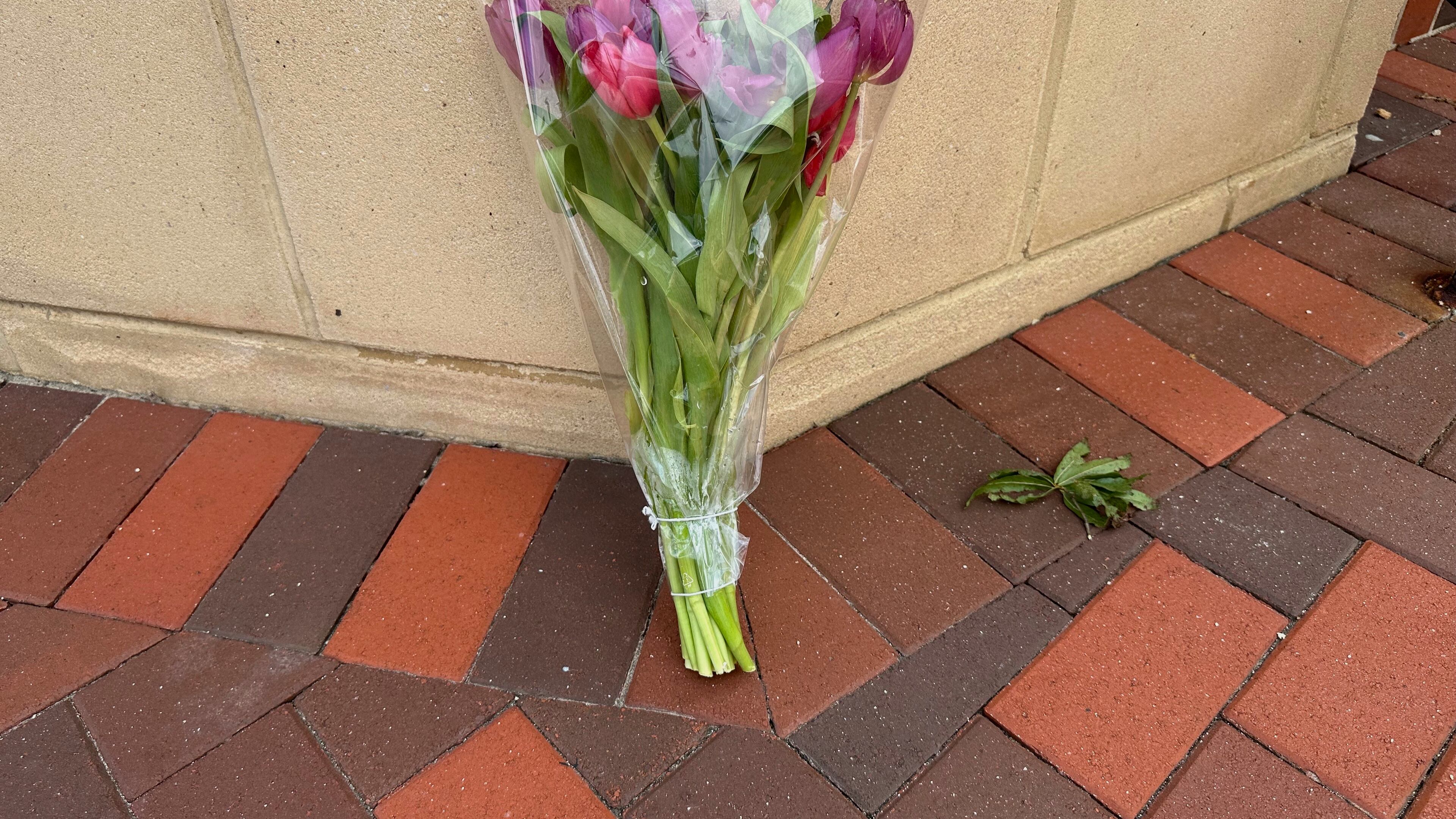 A lone bouquet sits outside a CVS pharmacy on Saturday, Aug. 9, 2025, near where police say a man was shooting at the headquarters of the U.S. Centers for Disease Control and Prevention in Atlanta (AP Photo/Jeff Amy)