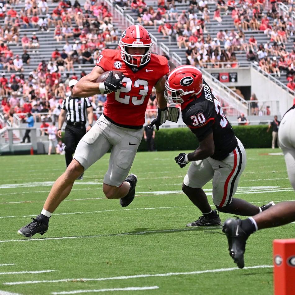 Georgia tight end Jaden Reddell (23) runs past Georgia linebacker Terrell Foster (30) during 2026 G-Day spring football game at Sanford Stadium, Saturday, April 18, 2026, in Athens. (Hyosub Shin/AJC)