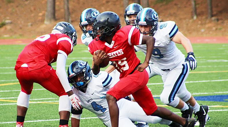 The Lovett defense takes off after Stone Mountain's Jaden Dupree. (Photo - Mark Brock)