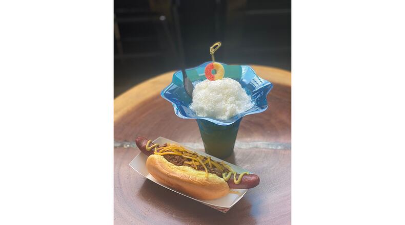 The Cream Peach, based on one of Little Spirit’s best-selling cocktails the King Peach, is made with bourbon, Aperol, lemon, mint, allspice dram, sugar and condensed milk, with Little Spirit's chili dog. / Photo courtesy of Little Spirit