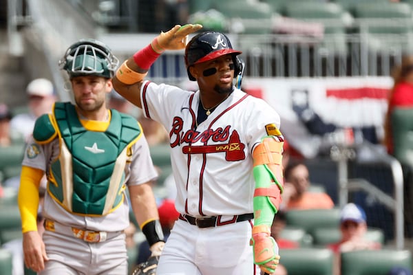 Ronald Acuña Jr. taps on his helmet to challenge an early season strike call. (Miguel Martinez/AJC)