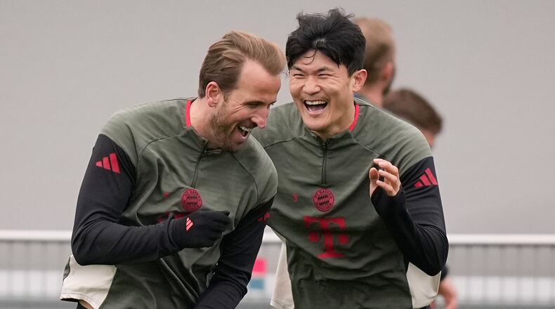 Bayern's Kim Min-jae and Bayern's Harry Kane having fun during a training session ahead of the Champions League quarterfinal second leg soccer match between Bayern Munich and Real Madrid in Munich, Germany, Tuesday, April 14, 2026. (AP Photo/Matthias Schrader)