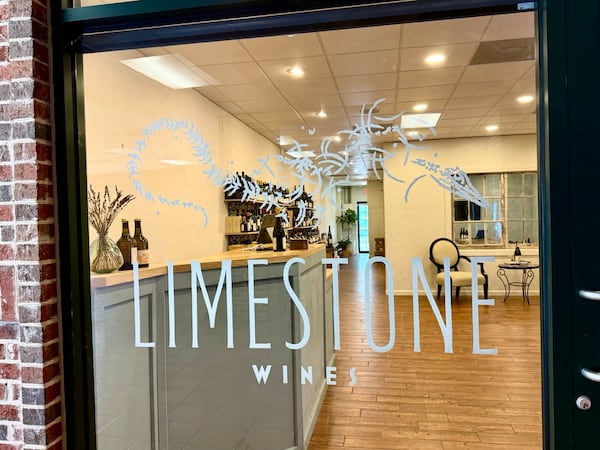 A shop window from the exterior with lettering that reads Limestone Wines.