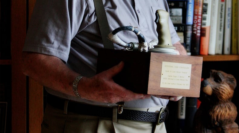 In this 2011 photo, Edgar Mitchell holds up the “rational hand control” that he used to help land the Apollo 14 Lunar Module “Antares” on the moon in February of 1971. Mitchell explained that NASA allowed him and all of the astronauts of his day to keep mementos from their trips into space. Yet, after choosing to sell a lunar camera that was aboard the Apollo 14 moon mission, he was sued by NASA. (Damon Higgins/The Palm Beach Post)