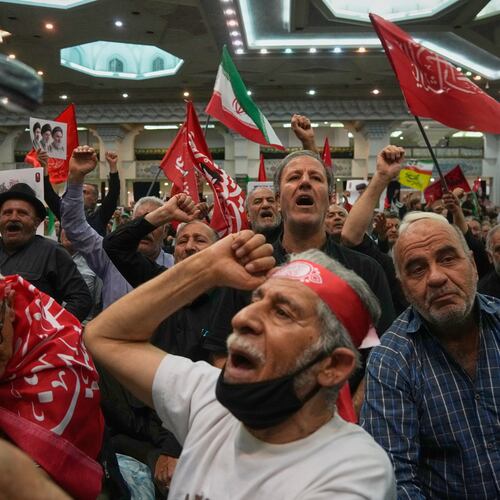 Mourners chant as they raise their fists during a gathering commemorating the late Supreme Leader Ali Khamenei at the Imam Khomeini Mosalla Grand Mosque in Tehran, Iran, Tuesday, July 14, 2026. (AP Photo/Vahid Salemi)