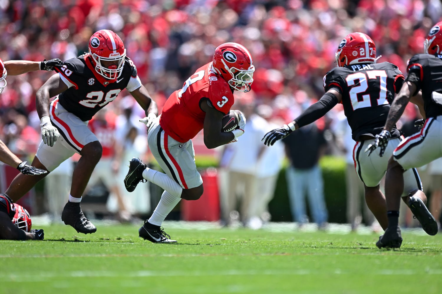 Georgia Red Team’s Nate Frazier (3) carries the ball for yardage against Georgia’s Black Team during the first half of the G-Day spring football game Saturday, April 12, 2025 at Sanford Stadium in Athens. (Daniel Varnado/For the Atlanta Journal-Constitution)