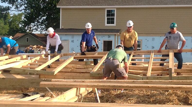 Volunteers including President Jimmy Carter raise the wall of a Habitat for Humanity home. The organization is in line to receive Community Development Block Grant funds to acquire seven to nine new house lots in Cherokee County. AJC FILE