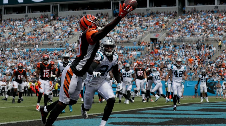 CHARLOTTE, NC - SEPTEMBER 23: A.J. Green #18 of the Cincinnati Bengals attempts a catch against James Bradberry #24 of the Carolina Panthers in the first quarter during their game at Bank of America Stadium on September 23, 2018 in Charlotte, North Carolina. (Photo by Streeter Lecka/Getty Images)