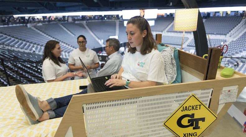 Natalie Larkins, a fourth year industrial design student at Georgia Tech, sits in her group’s demonstration bed during their presentation at the Capstone Expo in Atlanta last week.Two groups of students presented their projects for modified lofts two years after a Georgia Tech student, Clark Jacobs, fell out of his bed. (DAVID BARNES / dbarnes@ajc.com)