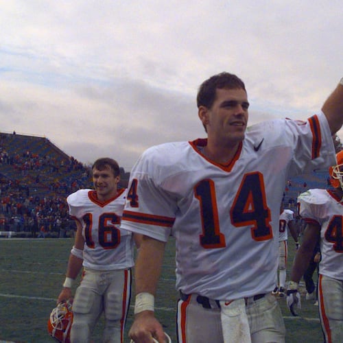 Georgia quarterback Mike Bobo waves as he walks off the field after beating Ole Miss in 1997. Current UGA coach Kirby Smart (16) walks behind him. (AJC File)