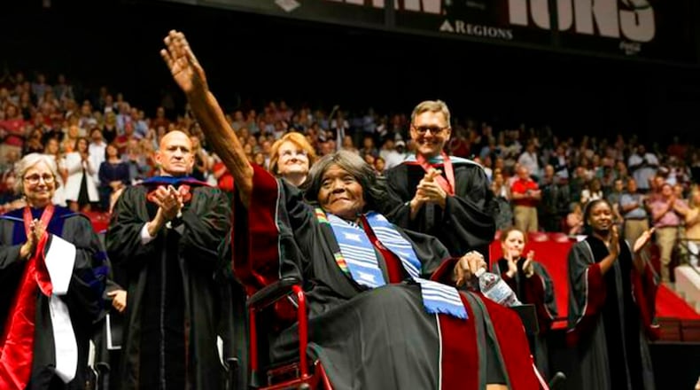 This photo provided by UA Strategic Communications Autherine Lucy Foster acknowledges the crowd as she receives a an honorary doctoral degree during a commencement exercise at The University of Alabama on Friday, May 3, 2019 in Tuscaloosa, Ala. The university bestowed the honorary doctorate degree to Foster, the first African American to attend the university.