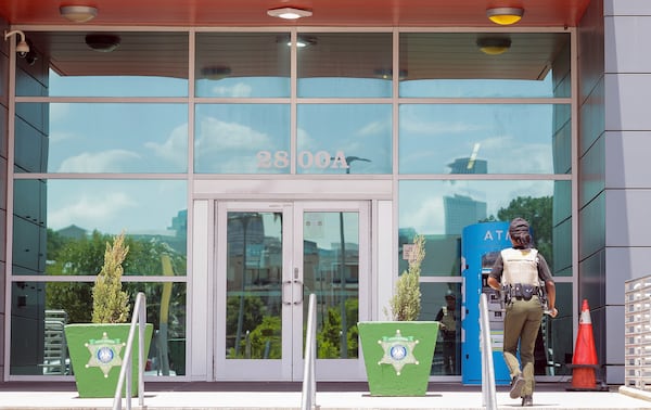 A law enforcement officer enters the Orleans Parish Sheriff's Office in New Orleans on Friday, May 16, 2025. (Brett Duke /The Advocate via AP)