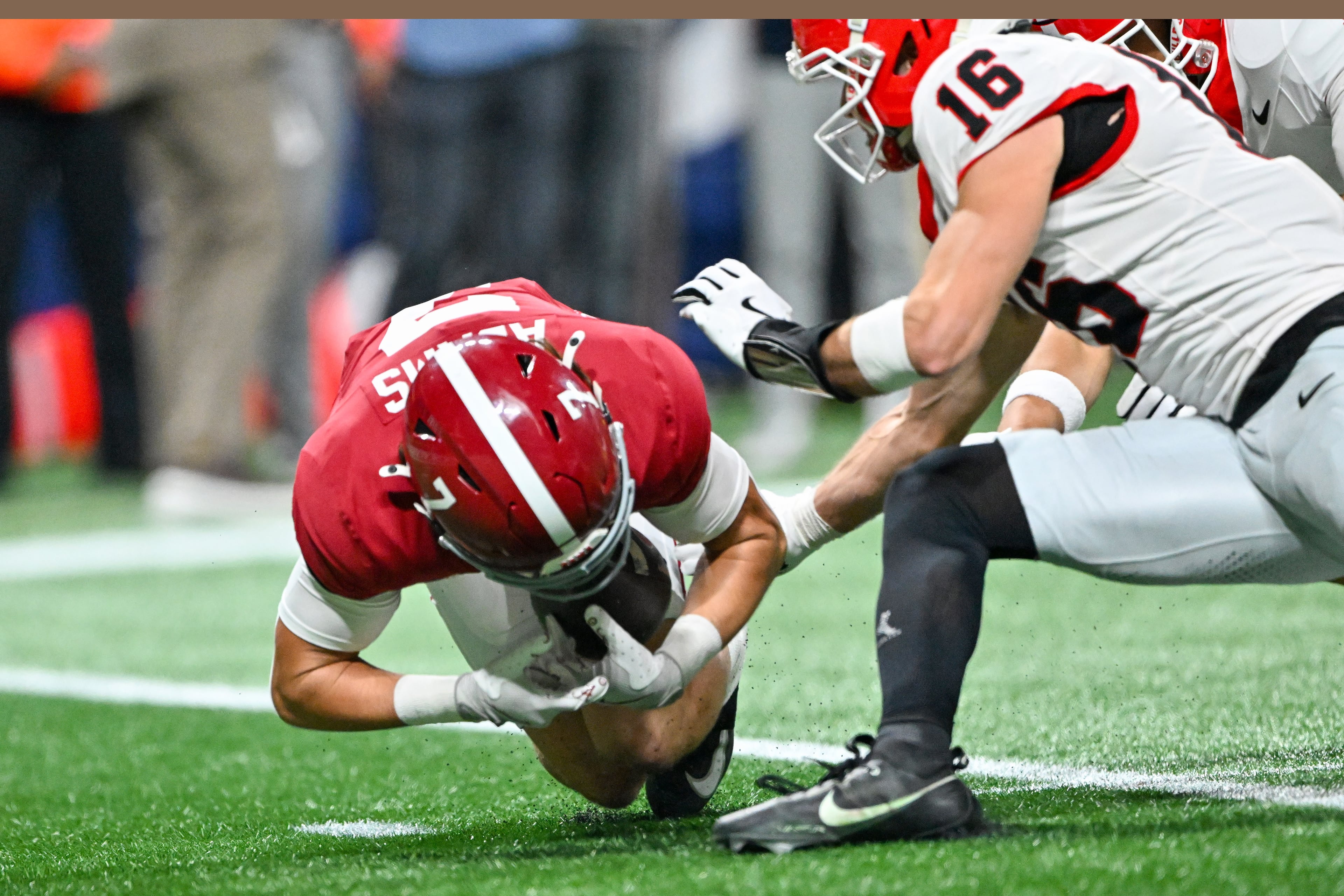 Alabama wide receiver Cole Adams (7) fumbles the ball but recovers in front of Georgia defensive back Maurice Hayes (16) during the fourth quarter of the SEC Championship game at Mercedes-Benz Stadium, Saturday, Dec. 6, 2025, in Atlanta. Georgia won 28-7. (Hyosub Shin / AJC)