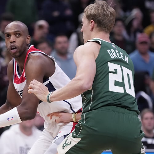 Washington Wizards' Khris Middleton tries to get past Milwaukee Bucks' AJ Green during the first half of an NBA basketball game Wednesday, Oct. 22, 2025, in Milwaukee. (AP Photo/Morry Gash)