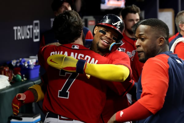 Braves right fielder Ronald Acuna, facing, and shortstop Dansby Swanson (7) celebrate their runs scored off of a double by second baseman Ozzie Albies (not pictured) during the seventh inning against the Miami Marlins at Truist Park Friday, May 27, 2022, in Atlanta. (Jason Getz / Jason.Getz@ajc.com)