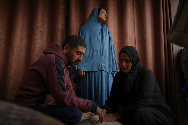 Members of the Al-Kahlout family mourn over the bodies of their relatives killed during an Israeli army strike before their burial at the Baptist hospital in Gaza City, Monday, March 24, 2025.(AP Photo/Jehad Alshrafi)