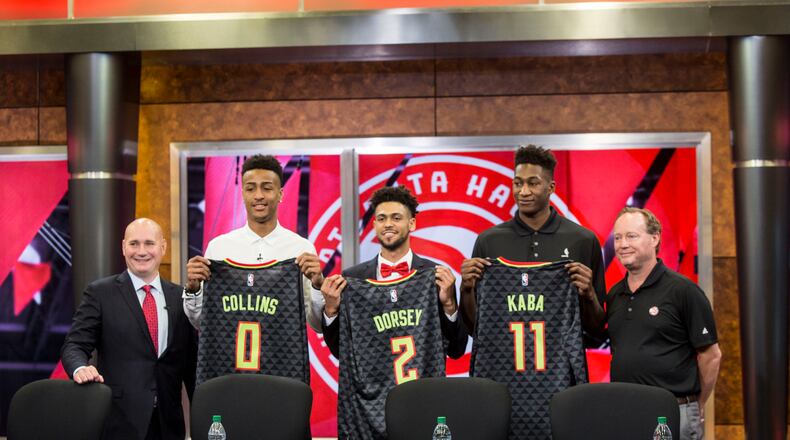 Atlanta Hawks General Manager, Travis Schlenk (far left), and Head Coach Mike Budenholzer (far right), stand on the outside of rookies: John Collins (left), Tyler Dorsey (middle) and Alpha Kaba (right).  Chad Rhym/ Chad.Rhym@ajc.com