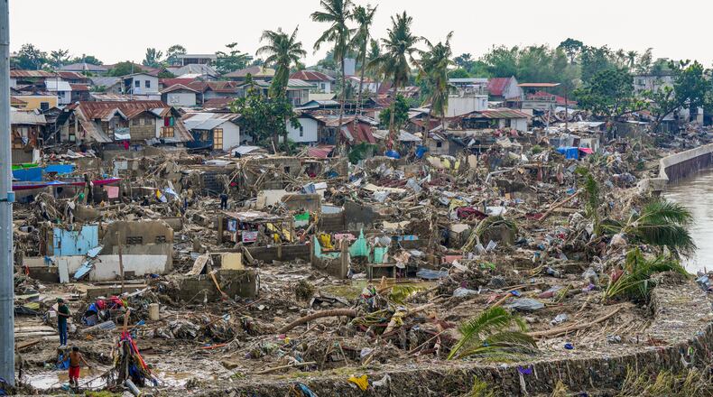 In this photo provided by the Malacanang Presidential Communications Office, damaged homes beside Mananga Bridge in Talisay, Cebu Province, central Philippines on Friday Nov. 7, 2025 after Typhoon Kalmaegi devastated the province and claimed lives. (Malacanang Presidential Communications Office via AP)
