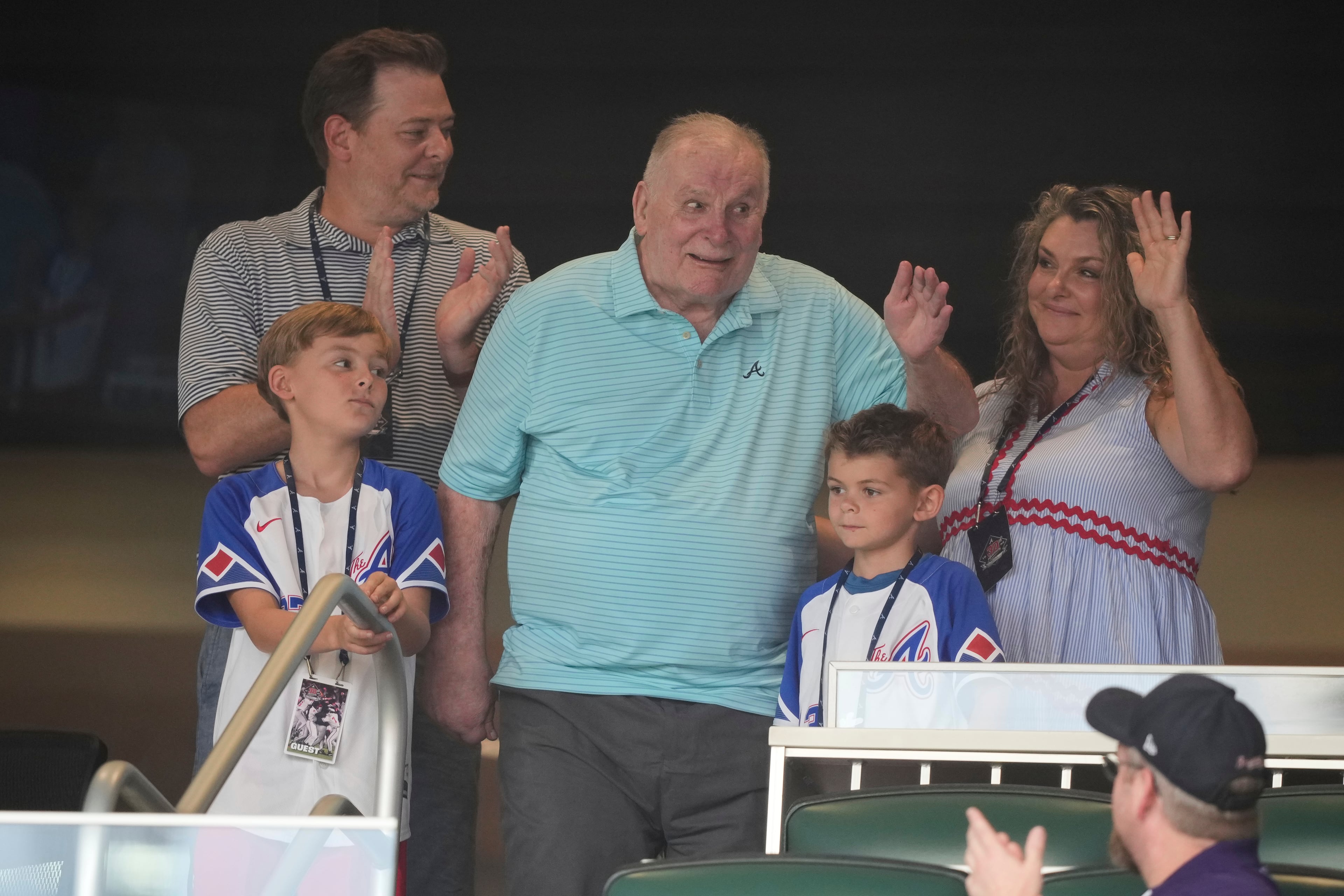 Braves legend Bobby Cox (center) waves to fans at Truist Park last week.