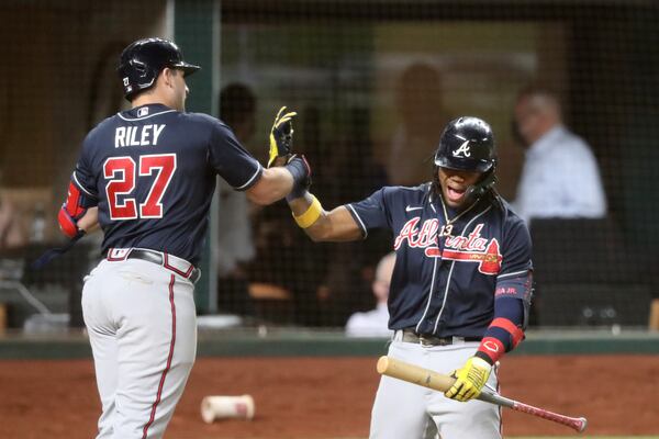 Braves third baseman Austin Riley (27) celebrates his solo home run with center fielder Ronald Acuna. (Curtis Compton / Curtis.Compton@ajc.com)


