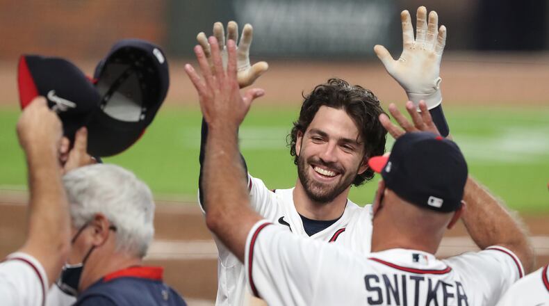 Braves shortstop Dansby Swanson gets a double high five from manager Brian Snitker after hitting a 2-RBI walk-off home run to beat the Washington Nationals 7-6 during the 9th inning in a MLB baseball game on Monday, August 17, 2020 in Atlanta.    Curtis Compton ccompton@ajc.com