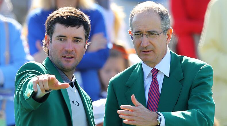Two-time Masters champion Bubba Watson and Comcast CEO Brian L. Roberts look over the 18th green during the Drive Chip & Putt National Finals at Augusta National Golf Club on April 1, 2018, in Augusta. (Curtis Compton/ccompton@ajc.com)