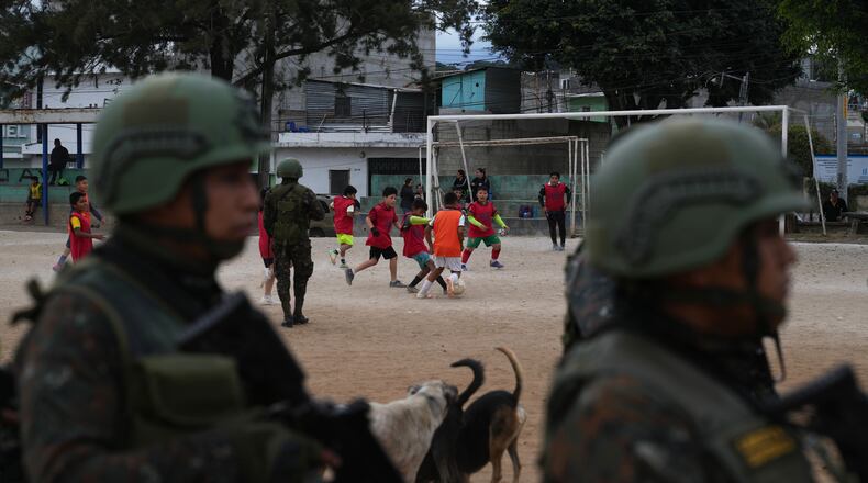 Soldiers receive instructions on a soccer field before patrolling the city during the country's state of emergency, following an escalation of gang-related violence, on the outskirts of Guatemala City, Tuesday, Jan. 20, 2026. (AP Photo/Moises Castillo)