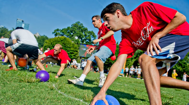 Players race to grab balls at the start of a game of dodgeball during the 2013 Boys & Girls Clubs of America's Day for Kids at Piedmont Park. Cobb County Parks is now beginning its first co-ed adult league.