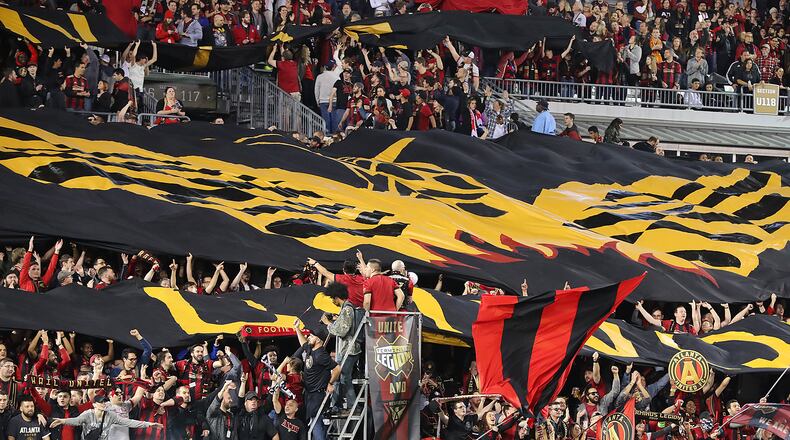 Fans unfurl the Atlanta United RC tifo to open the action against the N.Y. Red Bulls during their first game in franchise history on Sunday, March 5, 2017, in Atlanta. Curtis Compton/ccompton@ajc.com