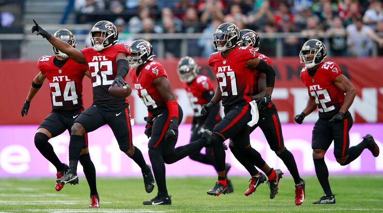 Falcons safety Jaylinn Hawkins (32) celebrates making an interception during the first half against the New York Jets Sunday, Oct. 10, 2021, at the Tottenham Hotspur stadium in London, England. (Ian Walton/AP)
