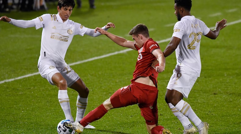 Atlanta United's Jurgen Damm (left) and  Mo Adams (right) challenge Toronto FC's Tony Gallacher during the first half Sunday, Oct. 18, 2020, in East Hartford, Conn. Toronto won 1-0. (Jessica Hill/AP)