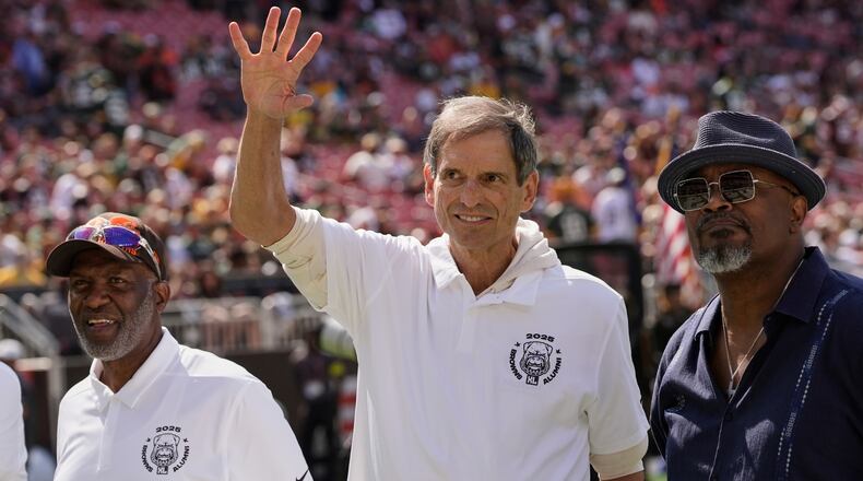 FILE - Former Cleveland Browns quarterback Bernie Kosar waves during a Browns' Alumni event before an NFL football game between the Green Bay Packers and the Cleveland Browns in Cleveland, Sunday, Sept. 21, 2025. (AP Photo/Sue Ogrocki, File)
