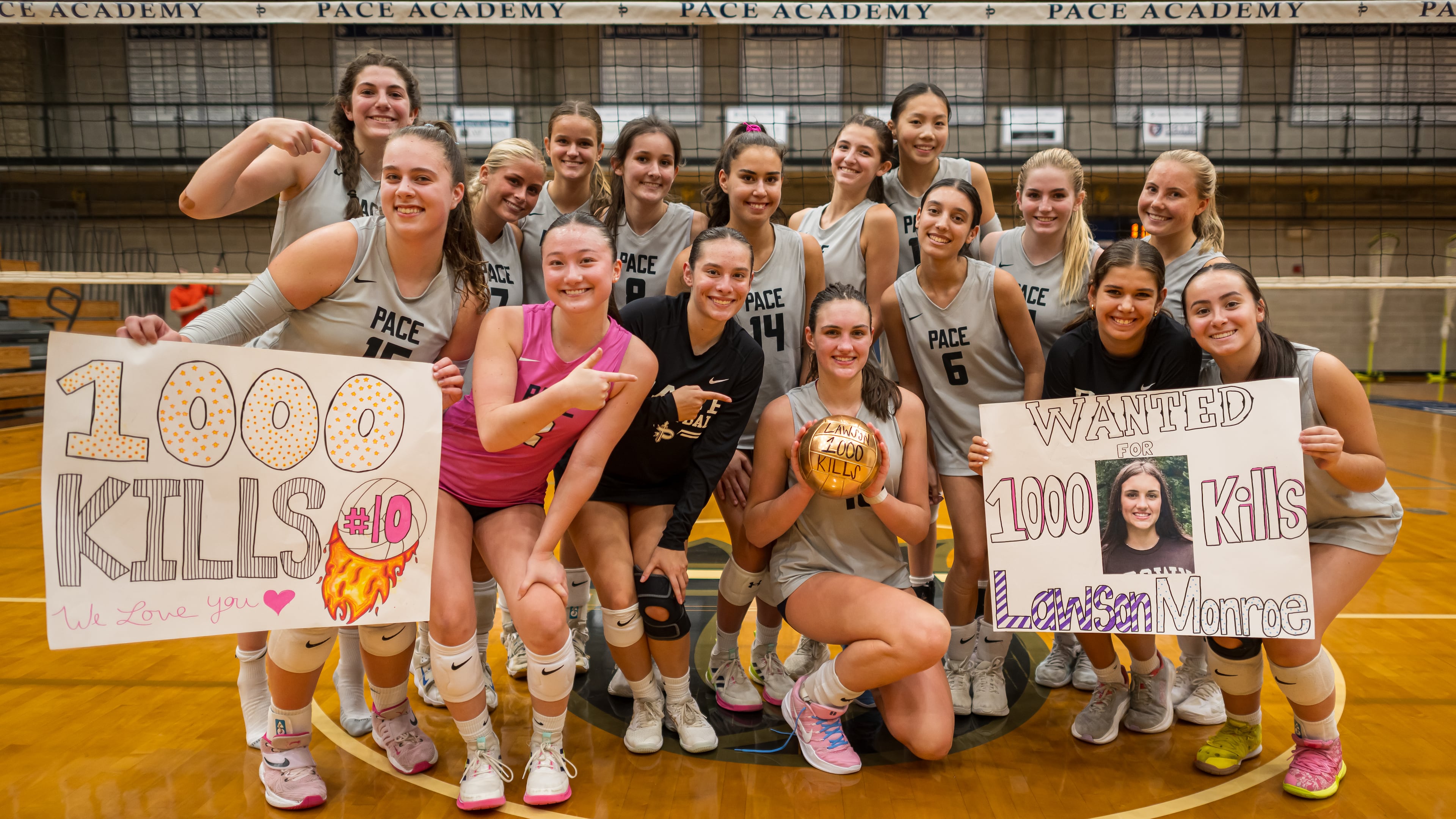 The Pace Academy volleyball team celebrates Lawson Monroe (center, with volleyball) for her  1,000th career kill earlier this season. (Courtesy of Dave Quick)