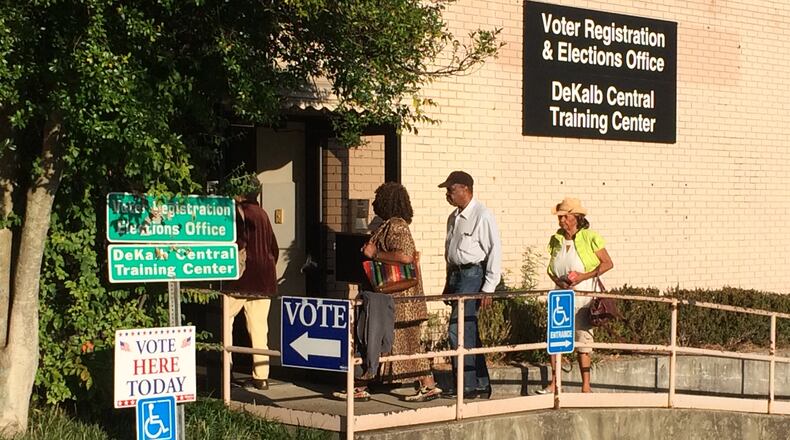 Voters walk into the DeKalb County Voter Registration and Elections Office off Memorial Drive on Oct. 17 as early voting begins. KENT JOHNSON / KDJOHNSON@AJC.COM