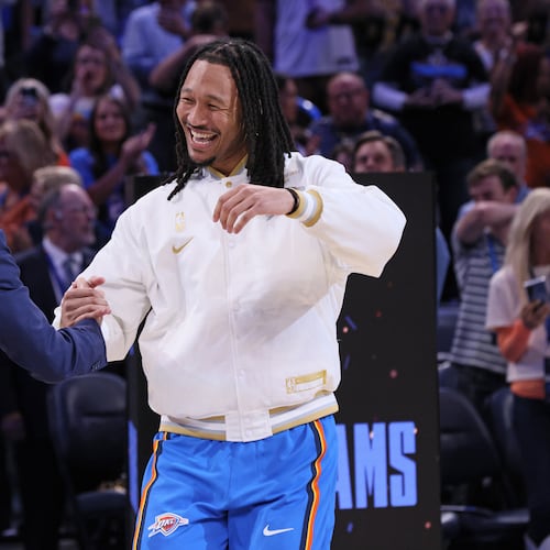 Oklahoma City Thunder forward Jaylin Williams, right, greets NBA commissioner Adam Silver during the championship ring ceremony before an NBA basketball game against the Houston Rockets, Tuesday, Oct. 21, 2025, in Oklahoma City. (AP Photo/Nate Billings)