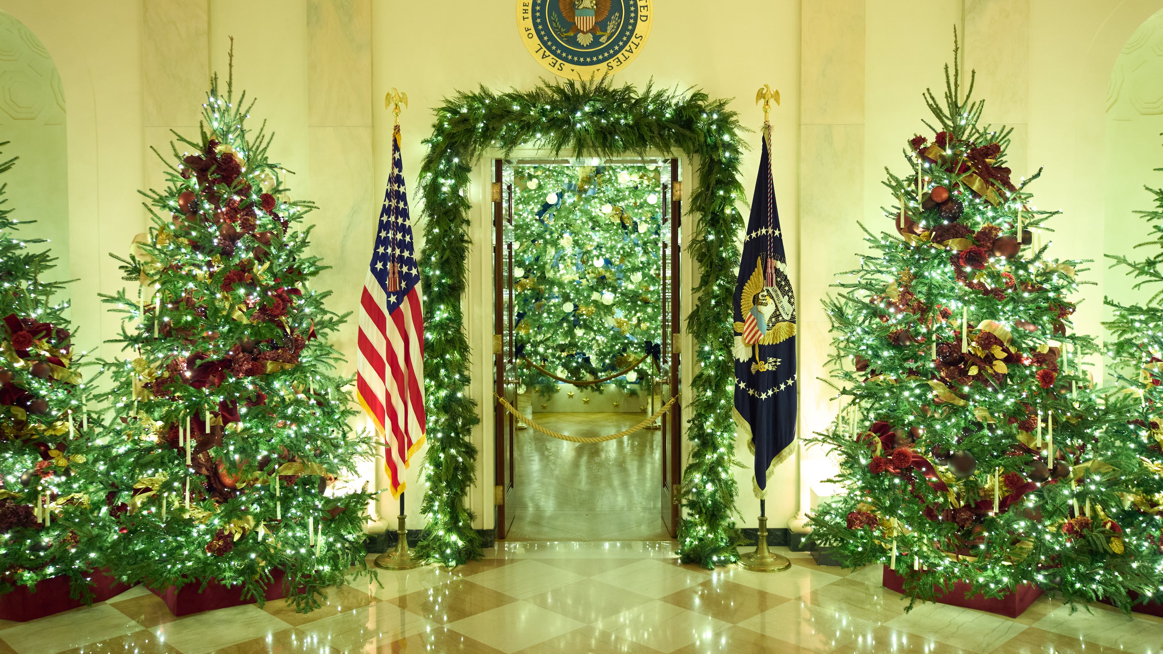 Christmas trees decorate the Cross Hall of the White House during a press preview of the Christmas decorations "Home is Where the Heart Is," Monday, Dec. 1, 2025, in Washington. (AP Photo/Evan Vucci)