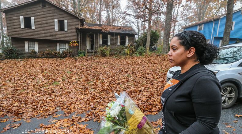 Brandace Colbert brought flowers Wednesday to the scene of a deadly house fire in Cobb County.