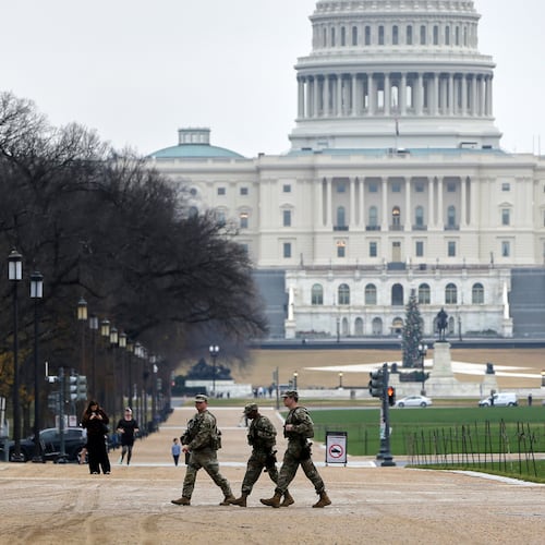 National Guard patrol on the National Mall near the U.S. Capitol, Wednesday, Nov. 26, 2025, in Washington. (AP Photo/Rahmat Gul)