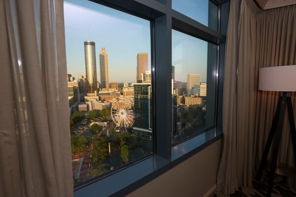 The Atlanta skyline is seen from the main bedroom of the presidential suite on the 28th floor in the newly remodeled top floor of the North Tower of the Omni Atlanta Hotel at Centennial Park. In 2024, more than 170 million visitors spent $45 billion at Georgia’s hotels, restaurants and other businesses. (Jason Getz/AJC)