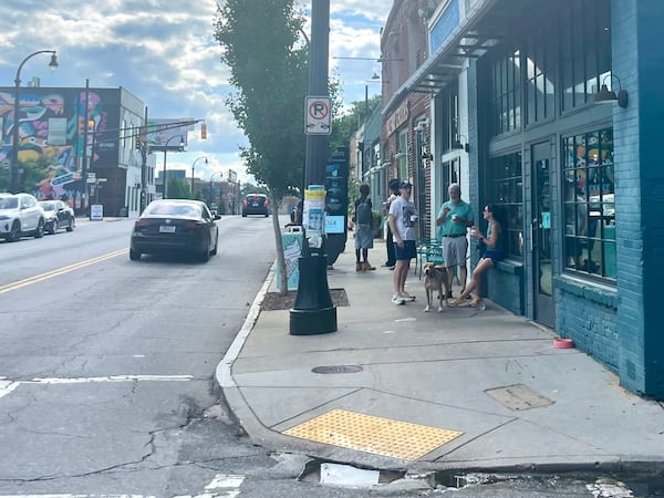 From left, David Swift, Jonathan Yaeger and Kirsten Ankrom enjoy some ice cream outside The Big Softie on Georgia Avenue, blocks from where the Braves once played. (Bill Torpy/AJC)