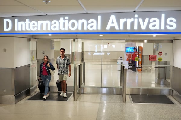 Luis Hernandez, 33, right, who traveled to Cuba for the Weekend arrives at Miami International Airport, Monday, June 9, 2025, in Miami. (AP Photo/Rebecca Blackwell)
