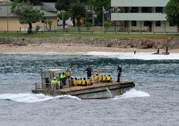 FILE - A group of Vietnamese asylum seekers are taken by barge to a jetty on Australia's Christmas Island on April 14, 2013. (AP Photo, File)