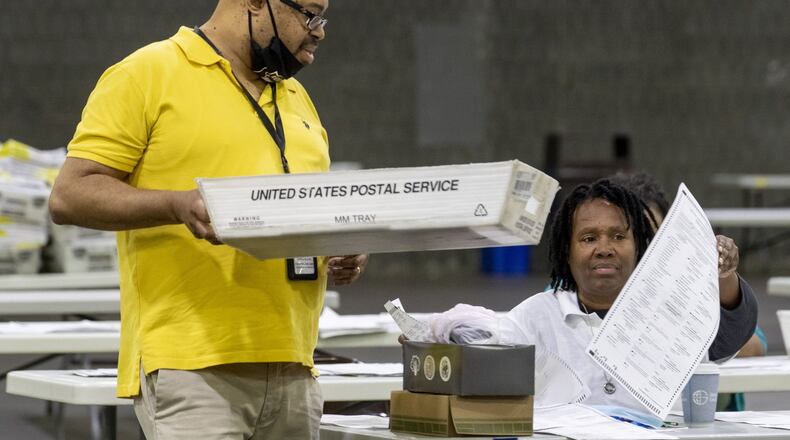 06/10/2020 - Atlanta, Georgia - Fulton County employees continue to count mail-in ballots the day after the Georgia primary election at the Georgia World Congress Center in Atlanta, Wednesday, June 10, 2020. A spokesperson for Fulton County said that they will announce the final number of mail-in ballots on Wednesday. (ALYSSA POINTER / ALYSSA.POINTER@AJC.COM)