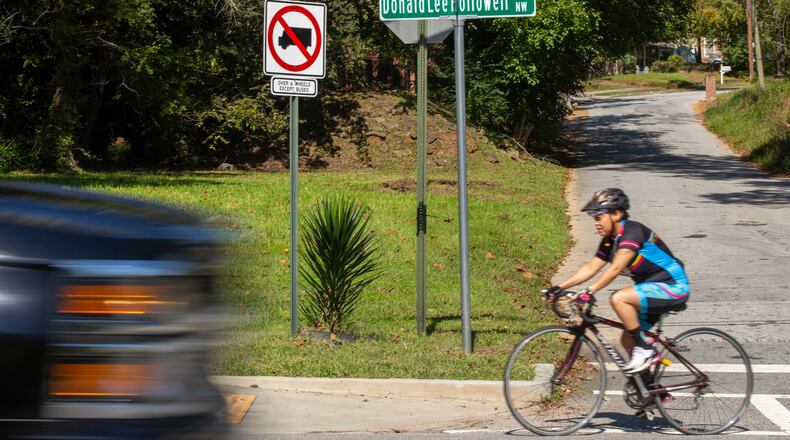 Rolanda Powell rides her bike down Donald Lee Hollowell Parkway in Atlanta, Georgia, on Tuesday, October 13, 2020. Rolanda Powell, head of her neighborhood organization, has been raising concerns about the safety of Donald Lee Hollowell Parkway following several recent fatalities. (Photo/Rebecca Wright for the Atlanta Journal-Constitution)