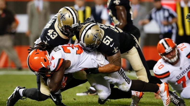 Cleveland Browns running back Isaiah Crowell (34) is tackled by New Orleans Saints linebacker Manti Te'o (51) and Marcus Williams (43) during the first half of an NFL preseason football game, Thursday, Aug. 10, 2017, in Cleveland. (AP Photo/Ron Schwane)
