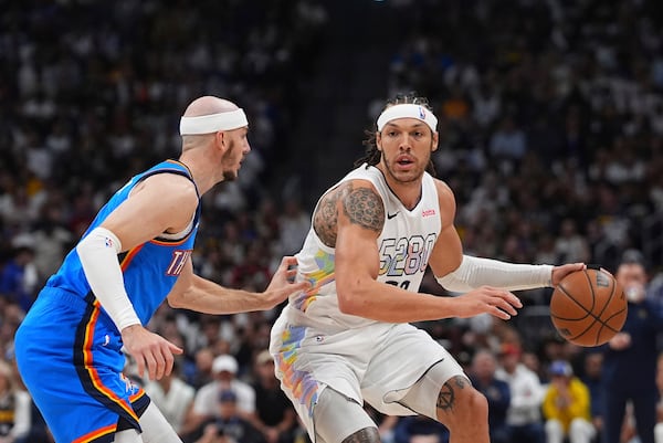Denver Nuggets forward Aaron Gordon, right, drives to the basket as Oklahoma City Thunder guard Alex Caruso defends in the first half of Game 6 in the Western Conference semifinals of the NBA basketball playoffs Thursday, May 15, 2025, in Denver. (AP Photo/David Zalubowski)