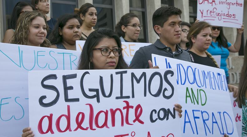 Several people gathered on the plaza of the J.J.Pickle Federal Building on Tuesday afternoon to protest President Donald Trump’s decision to rescind the Obama-era Deferred Action for Childhood Arrivals program, also known as DACA. Edilsa Lopez, left, a graduate of the University of Texas at Austin, and Jose Garibay, a current St. Edward’s University student, are both DACA status recipients who participated in a protest against the president’s action.